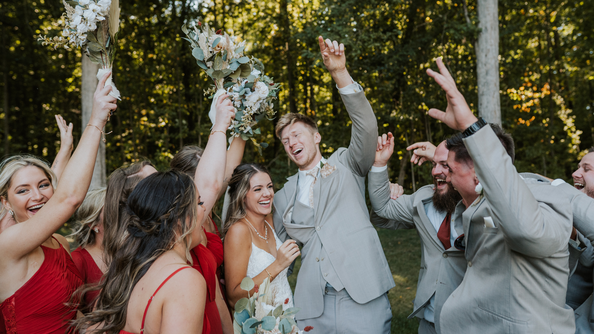 groomsmen and bridesmaids hyping up the newly engaged couple during their Cincinnati wedding.