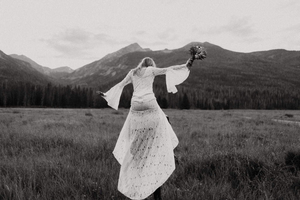 bride rides on her groom's back during their RMNP elopement on the Bowen Baker Trailhead. 