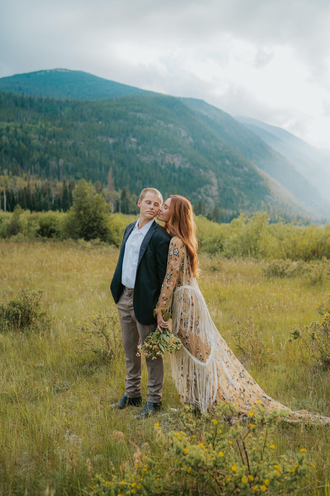 bride kissing her groom on the cheek during their Rocky Mountain National Park elopement.