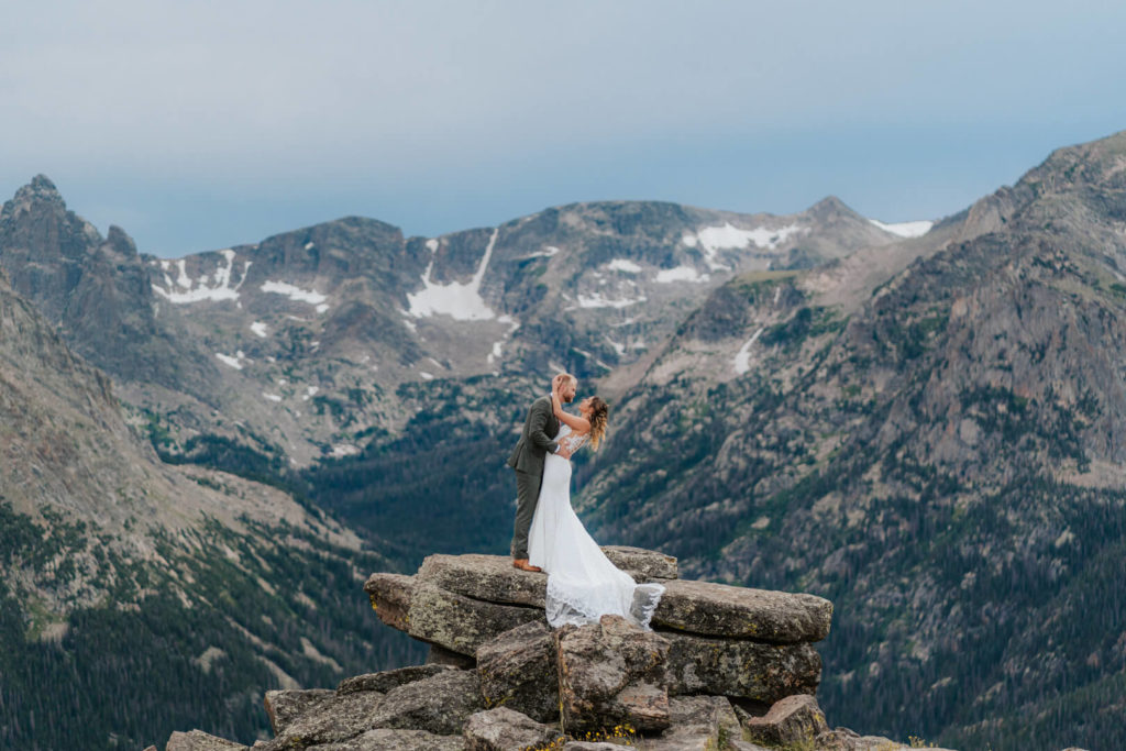Eloping couple kiss as they pose for a photo during their Rocky Mountain National Park elopement.