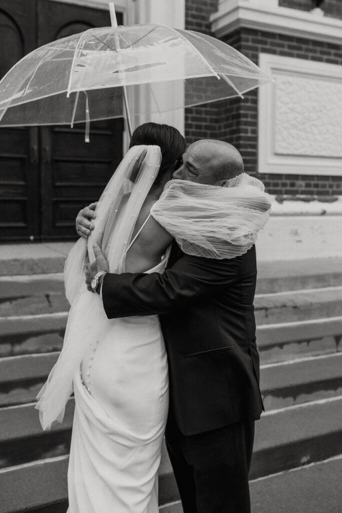father of the bride hugs his daughter